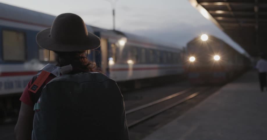 A woman waits for a train to arrive