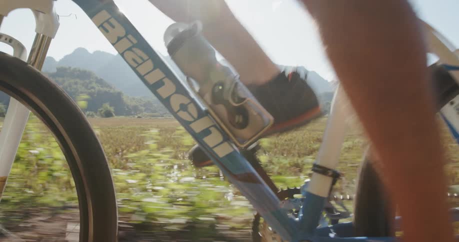 A bicyclist rides on a rural road