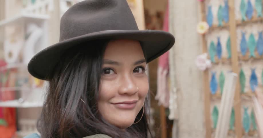 A woman tries on a hat