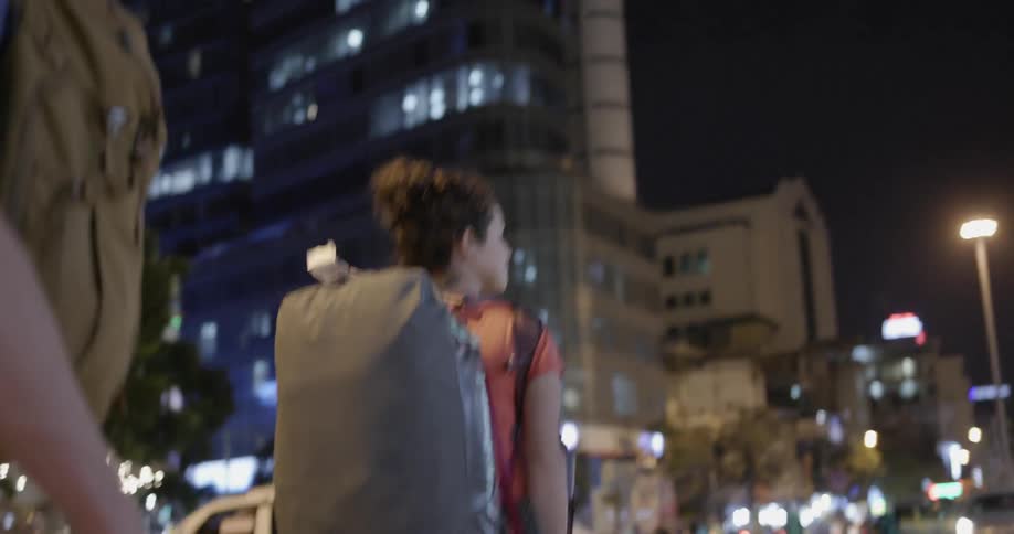 People are traveling down the city road at night