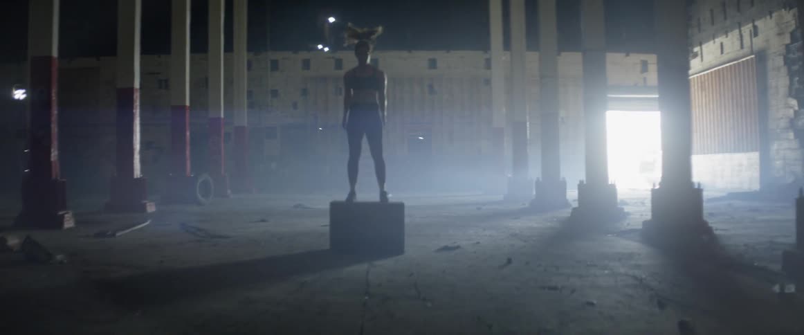 A woman is exercising jumping on a block
