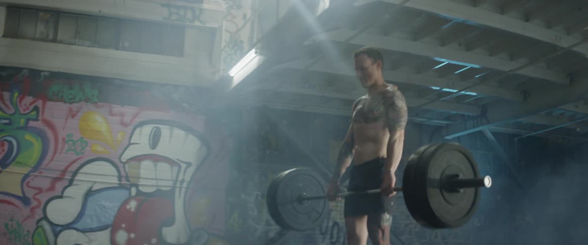 Man lifts a barbell then lowers it to the ground