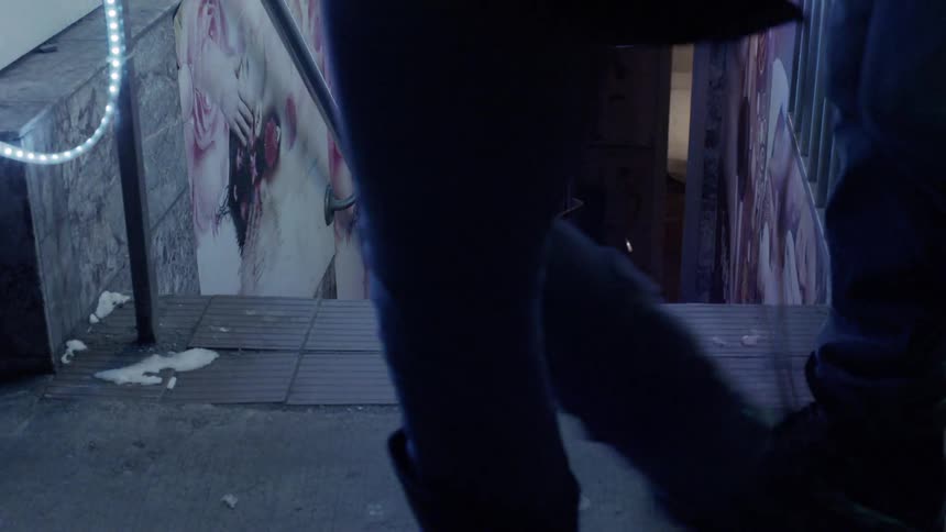 Pedestrians walk on a city sidewalk