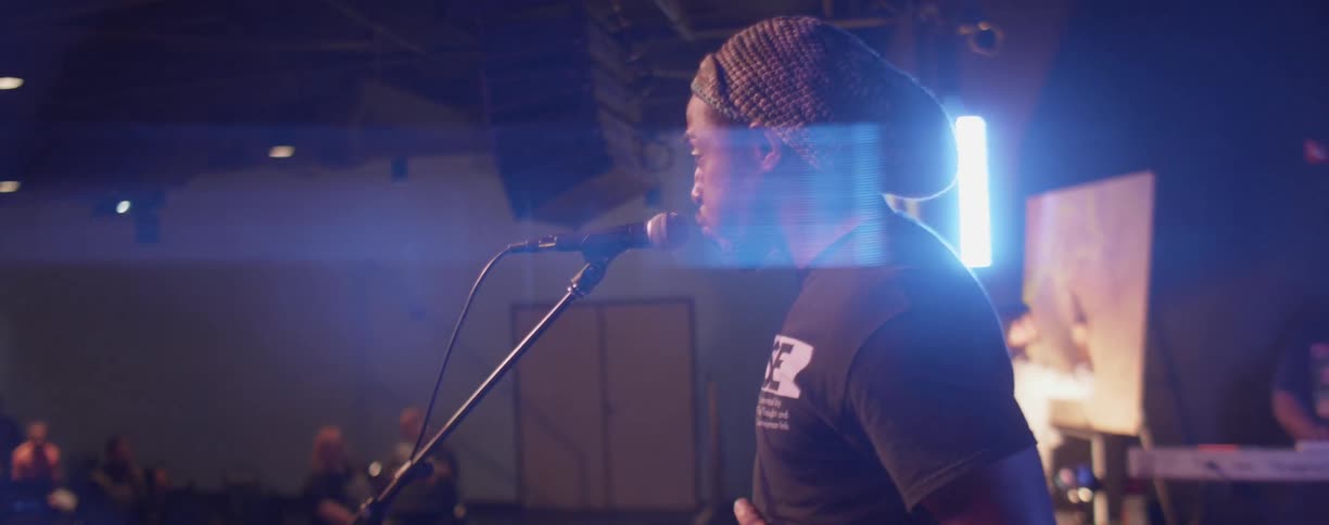 Man is singing on stage in night club