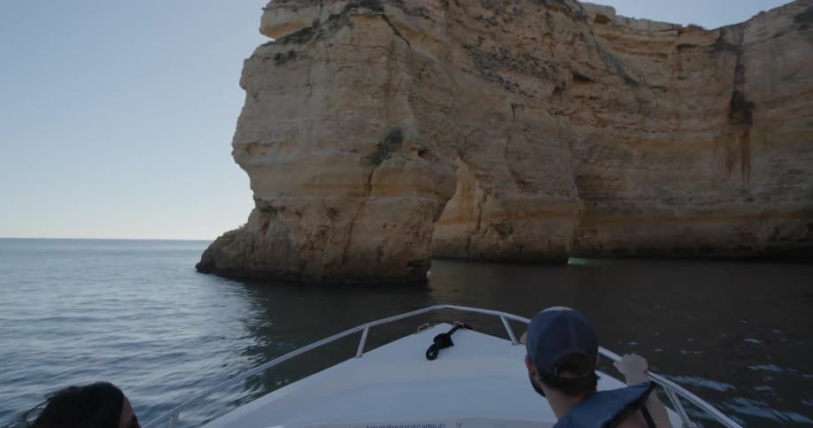 A man and woman ride on a speedboat