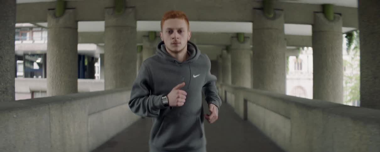 A man is jogging past the pillars