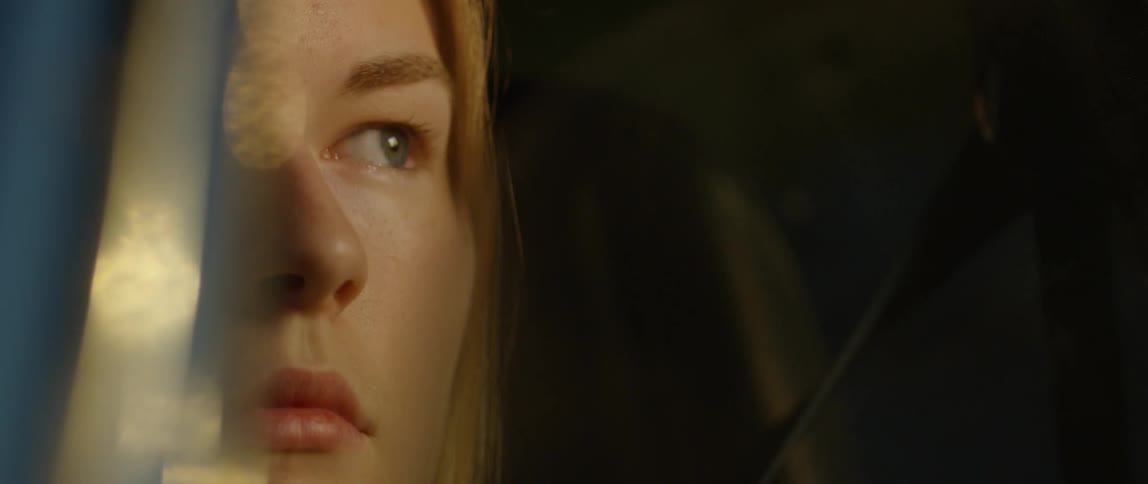 A woman sits in a car