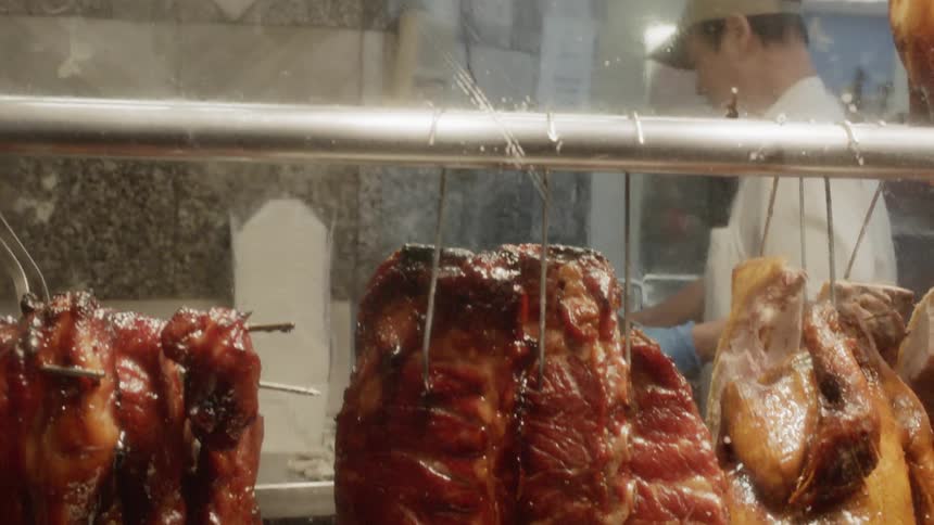 Cooked meat hangs in a restaurant
