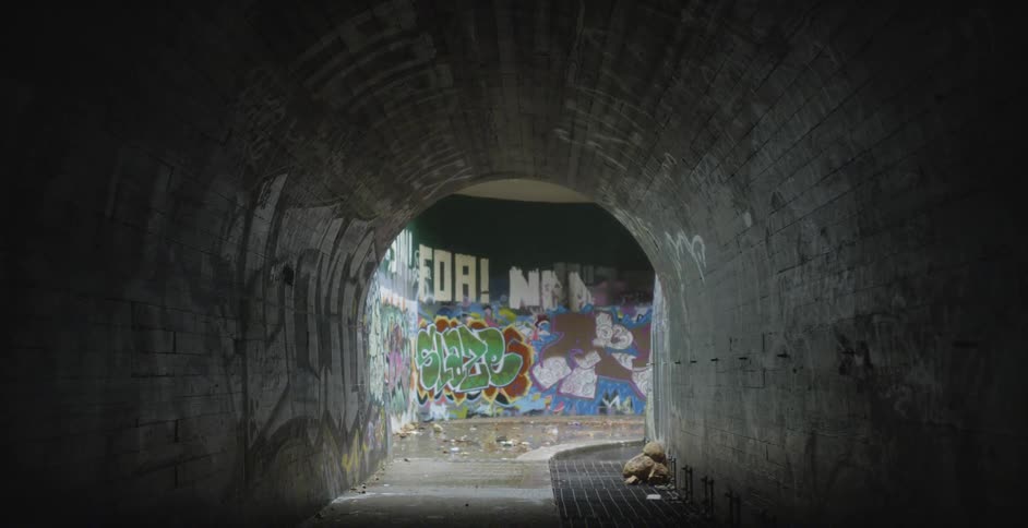 Graffiti covers a tunnel wall