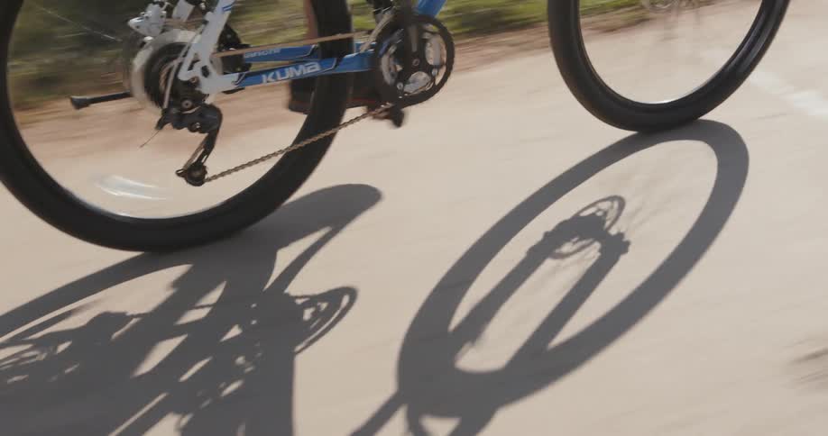 A bicyclist rides on a rural road