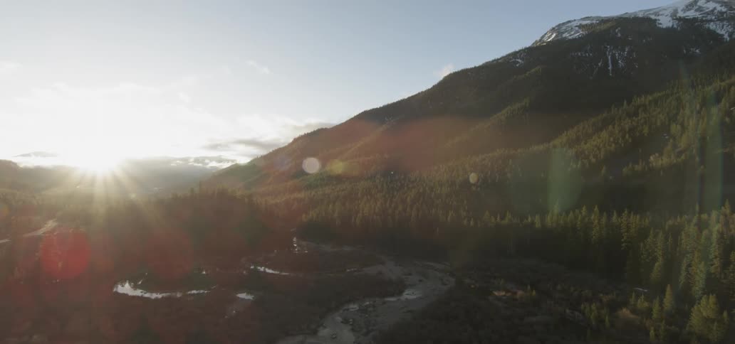 The sun shines over mountains
