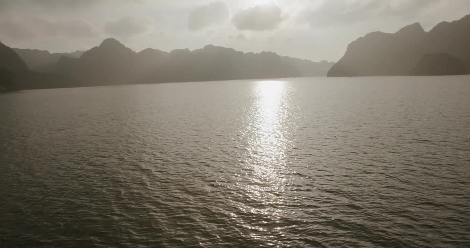 Sunlight glistening on lake water on cloudy day