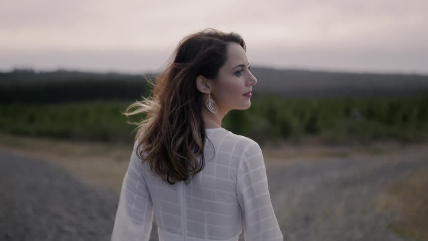 Woman  walks in the country and looks behind her