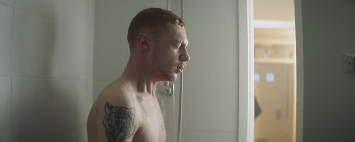Man closes his eyes while showering