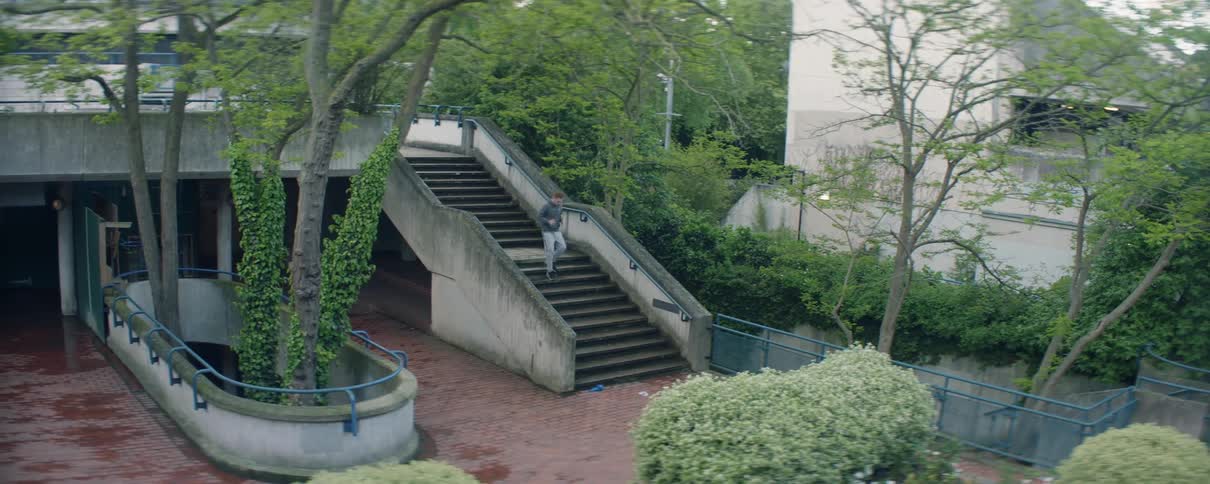 The man runs down the stairs