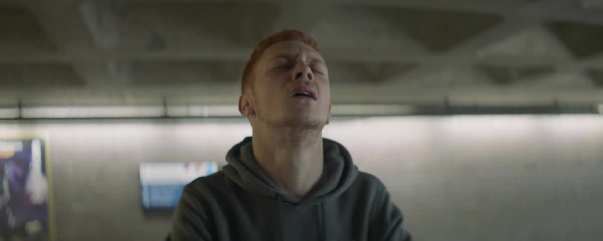 A redheaded man exhales in frustration