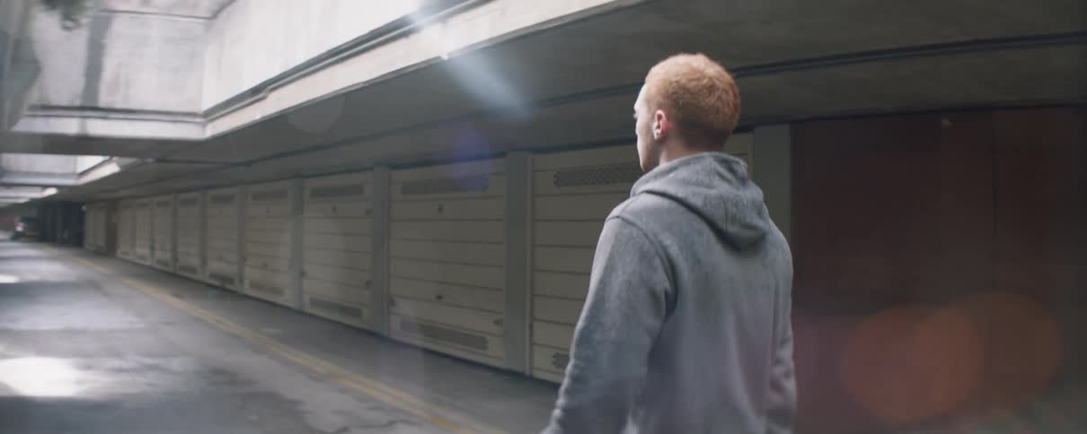 Man walks on a road in the rain