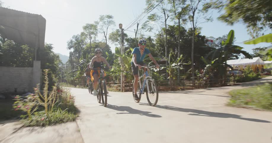 Bicyclists ride on a town road