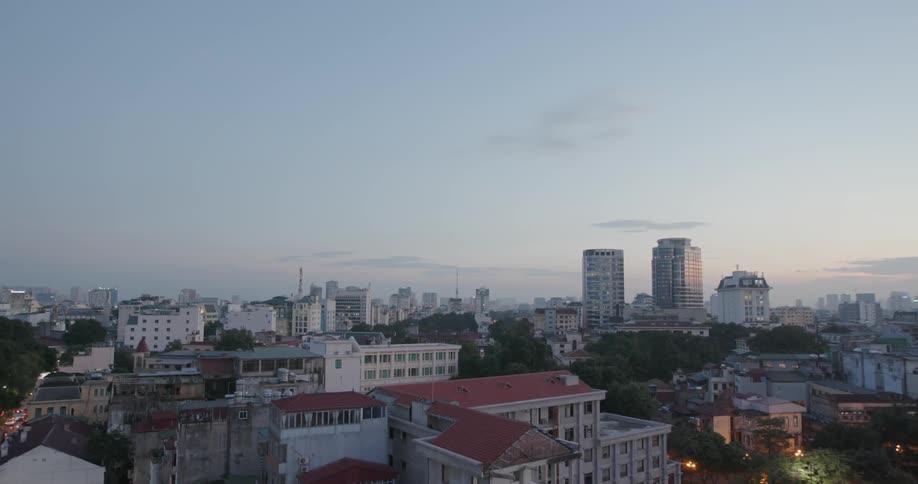 Buildings stand in a city at sunset
