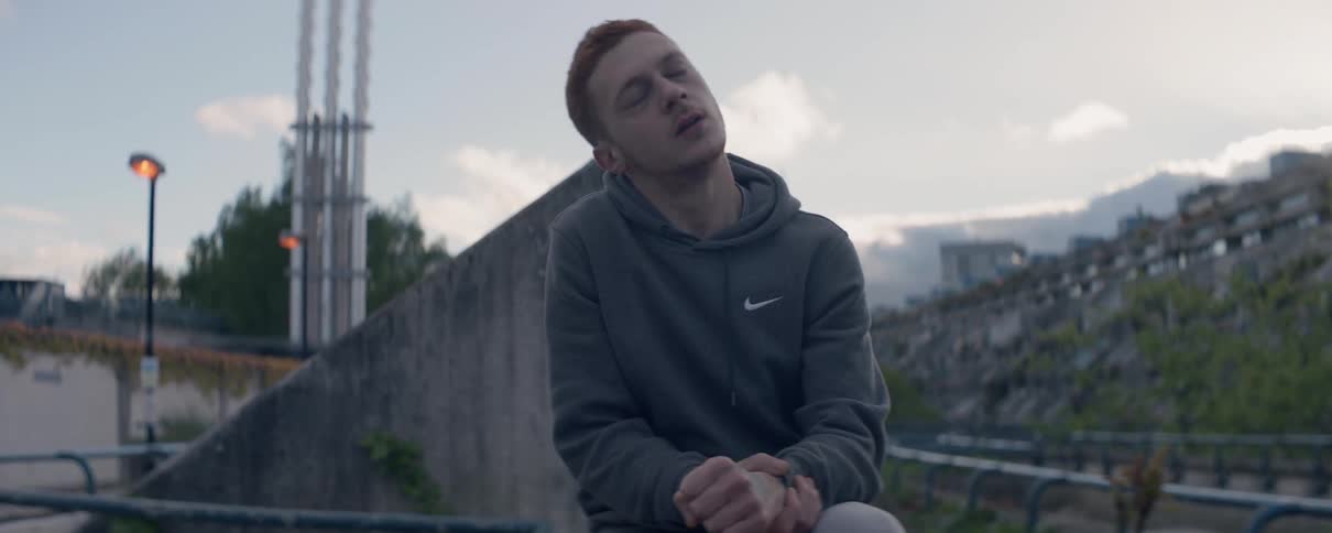 A man stretches his hand and neck outside