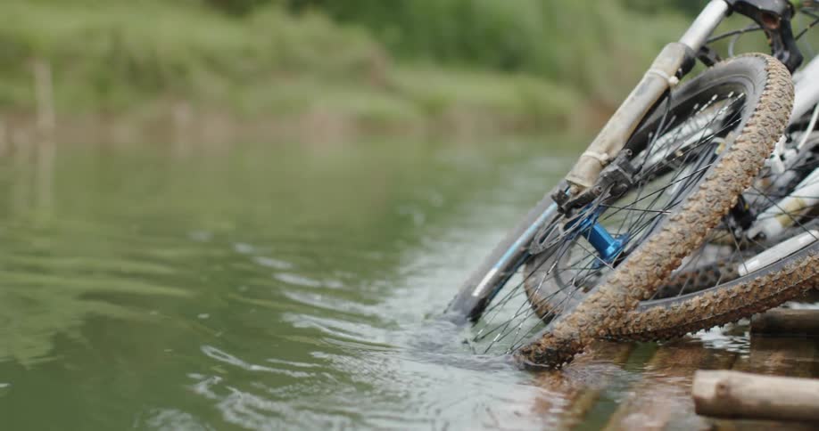 A boat pulls bicycles in the water