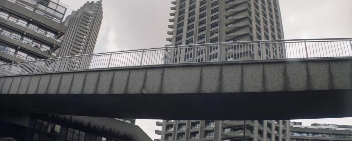 Man jogging across foot bridge in city