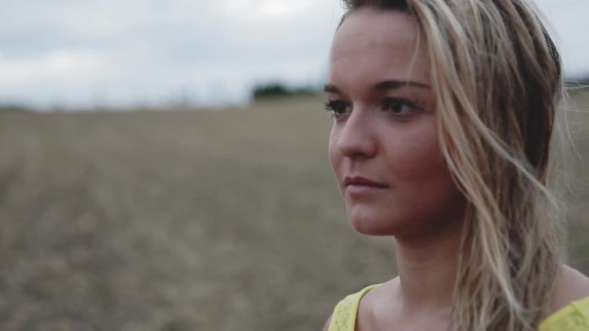 Woman stands in a rural field