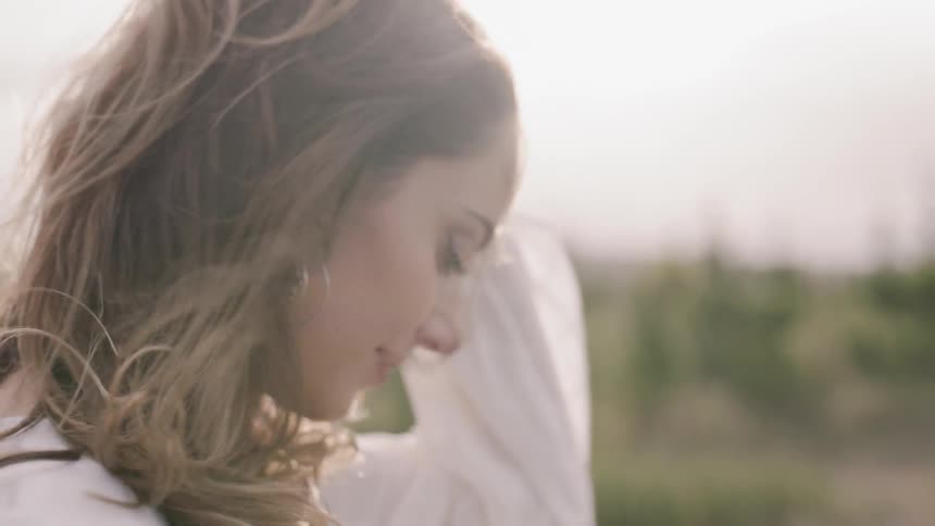 Woman outside in wind and sunlight
