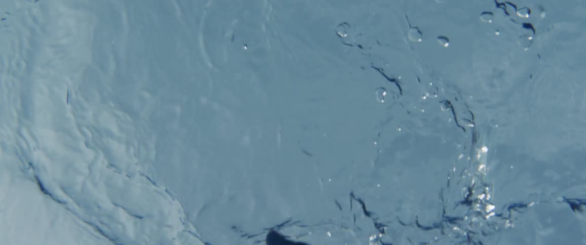 A woman waves her hand on the water surface