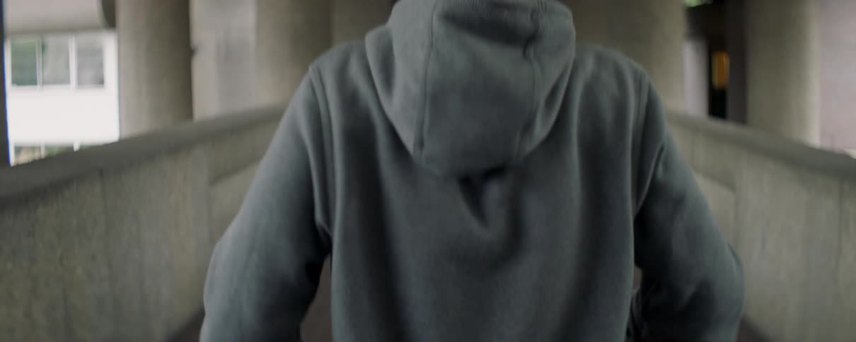A man stretches his shoulders outside