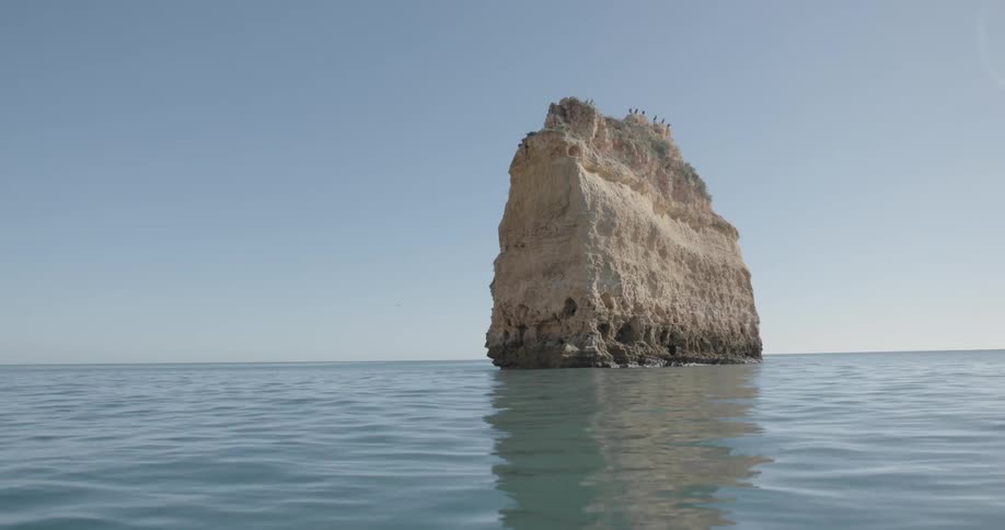 A rock formation stands in the ocean