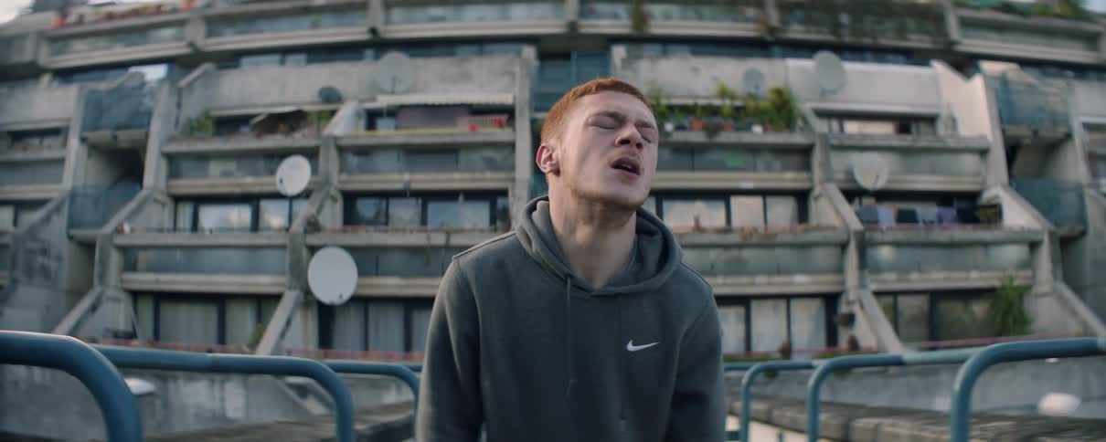 Man stands up looking like he is in pain