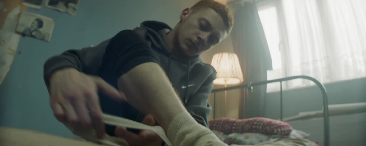 The man is wrapping his ankles