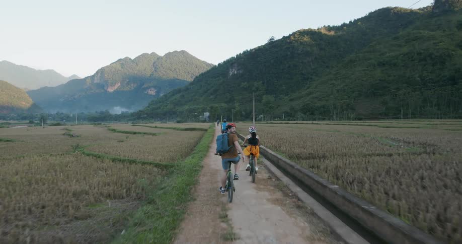 Bicyclists ride on a rural path
