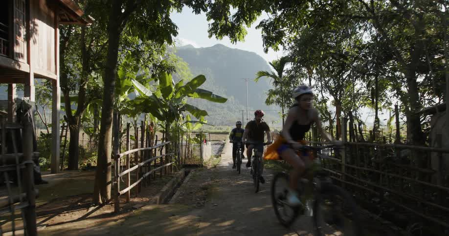 A group of people ride bikes together