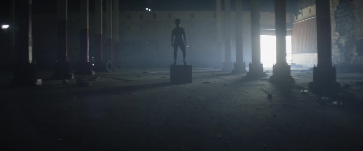 Woman exercises in an abandoned building