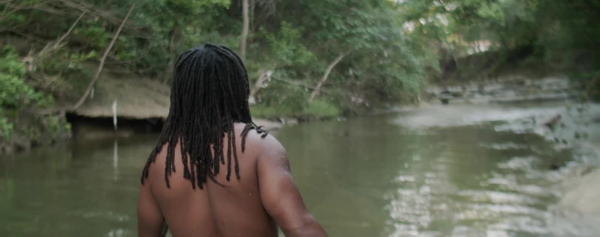 Man wades through a pond of water