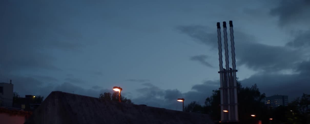 Three posts stand tall under the dark night sky