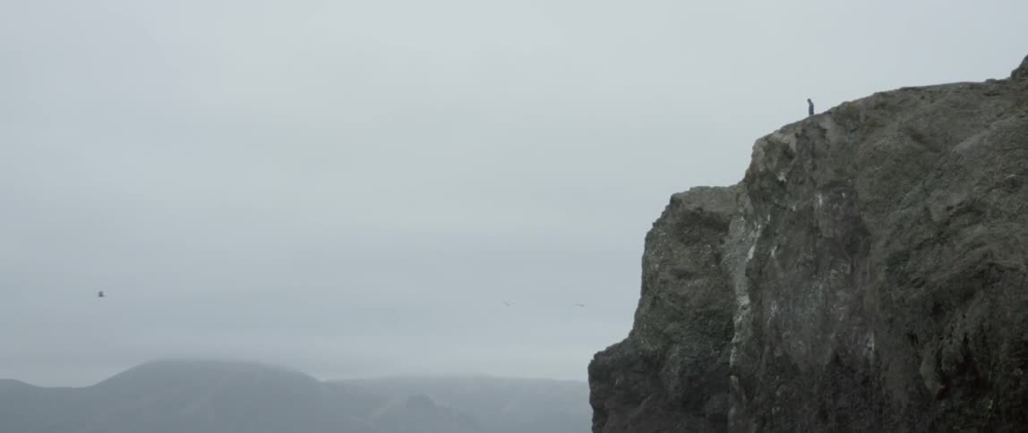 A man walks on the edge of the cliff