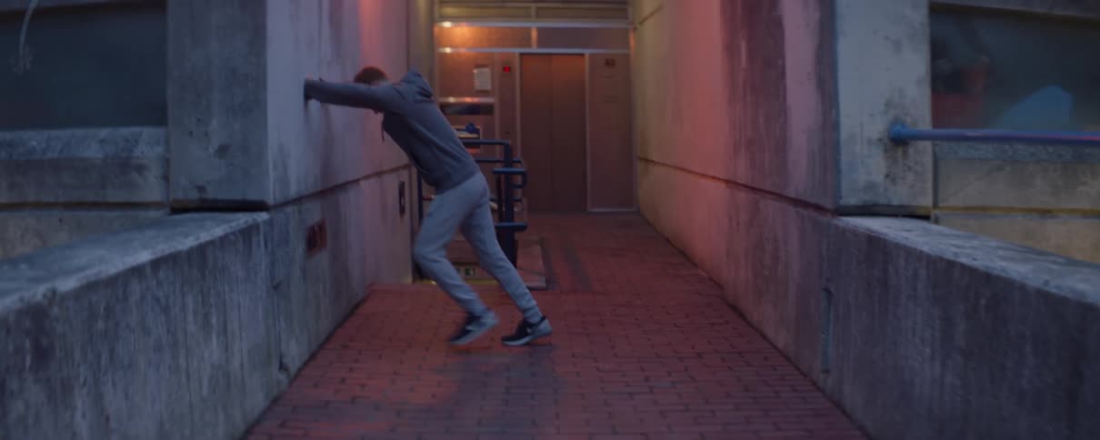 A man stretches in the corridor