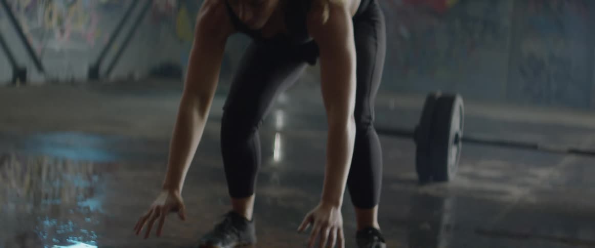 Woman does a push up then jumps into the air