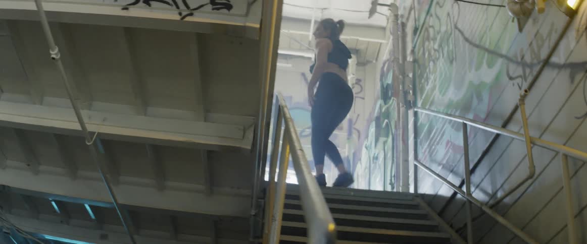 A woman works out by running up and down the steps