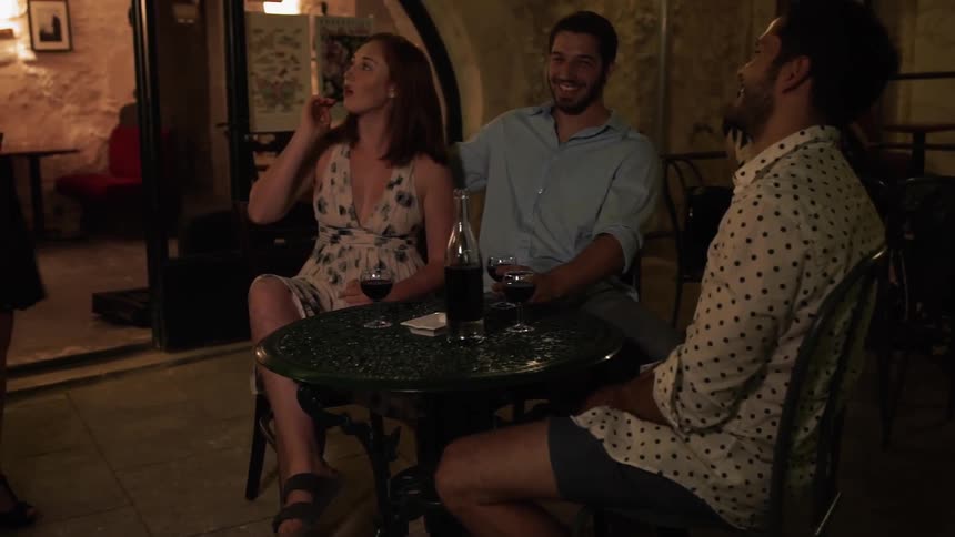 People are greeted outside at the table