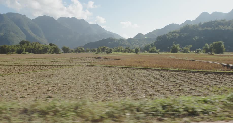 A car drives through a rural area