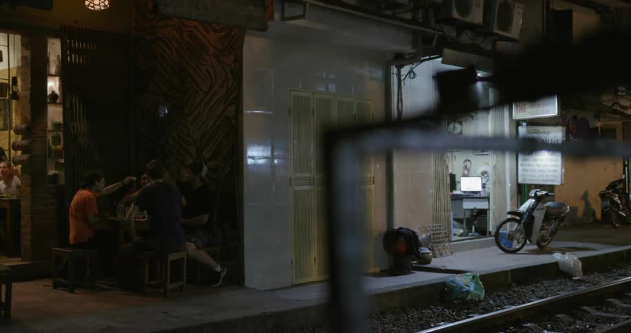 People outside at table at night in city