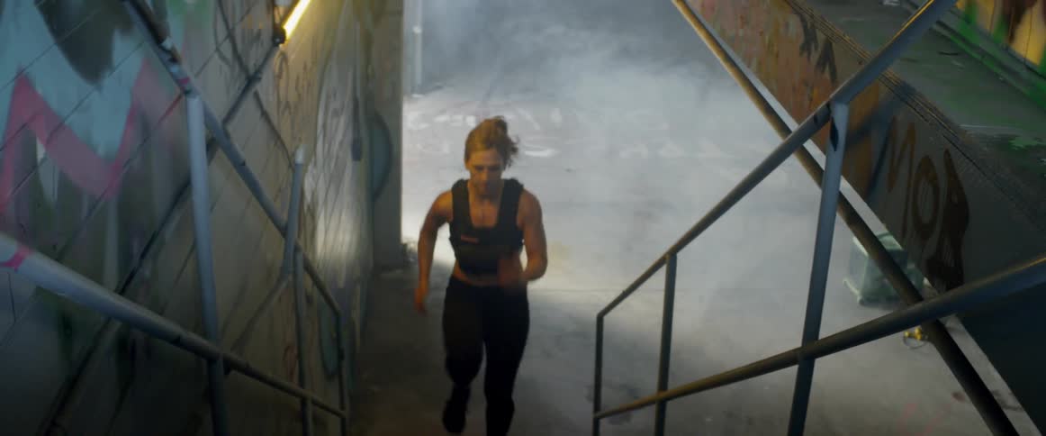 A woman runs up the stairs