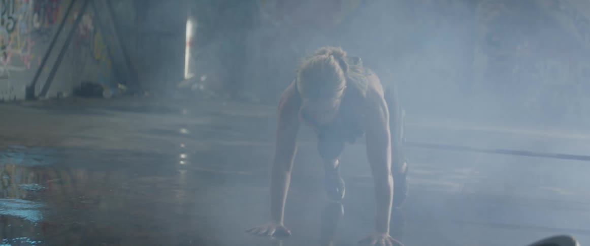 Woman does a push up then jumps into the air
