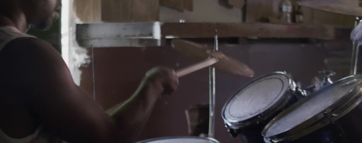 Man plays a set of drums