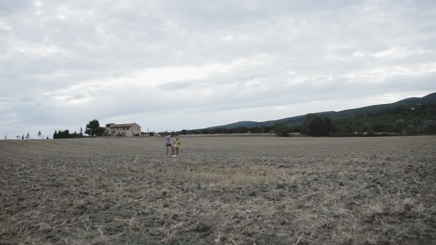 Two people kick a soccer ball over the field