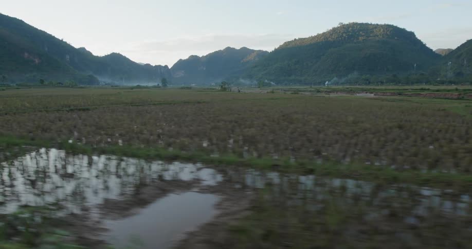 Field sits covered with water near the mountains